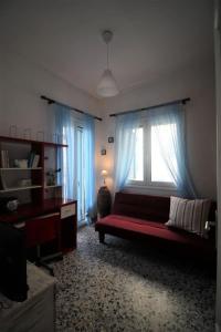 a living room with a couch and a window at The House on the Coast in Évdhilos