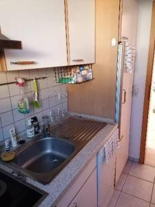 a kitchen with a sink and a counter top at MoMe Appartment in Groß Rönnau