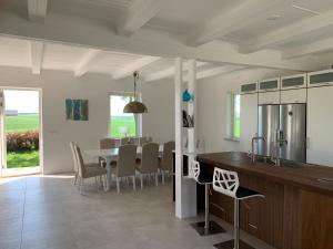 a kitchen and dining room with a table and chairs at Villa Baldringe in Ystad