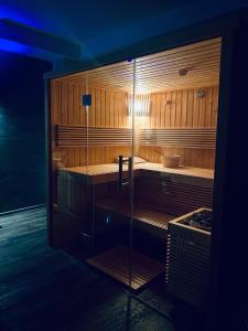 a sauna with wooden walls and a glass wall at CASA ANKELI in Buşteni