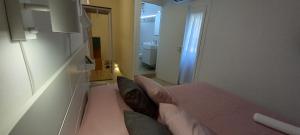 a room with a bed and a bathroom with a mirror at L'angoletto in Scicli