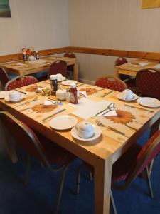 una mesa de madera con platos y utensilios. en The Sandgate, en Skegness