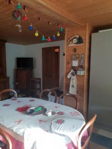 a dining room with a table and some christmas decorations at Les PLAGNES in Vailly