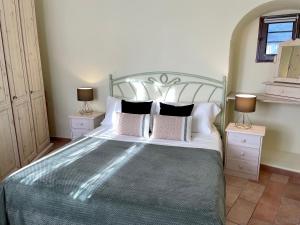 a bedroom with a large bed with two night stands at La Casa Grande di Pantelleria in Pantelleria