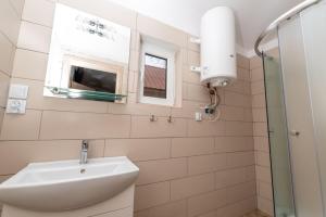a white bathroom with a sink and a window at Wola Wielka - Domki Wygoda Nr2 in Narol +48 photos