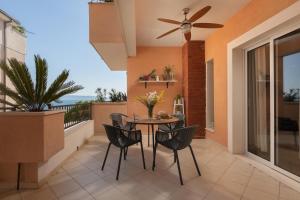 a patio with a table and chairs on a balcony at Waterfront Roko in Podgora