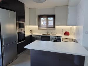 a kitchen with a white counter top and a refrigerator at Poros 2 Villa in Protaras
