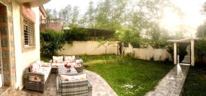 a patio with chairs and a table in a yard at Villa ain soltan in Imouzzer du Kandar