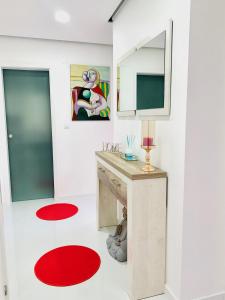 a room with a desk with a mirror and a red rug at Entire apartment in Lisbon plus Car in Lisbon