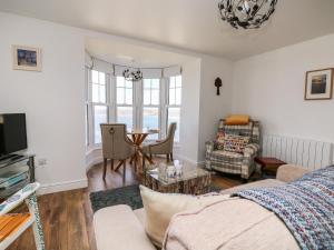 a living room with a couch and a table at Sennen Heights in Sennen Cove