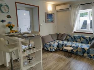 een woonkamer met een bank en een tafel bij ILOVIK FLOWER in Ilovik
