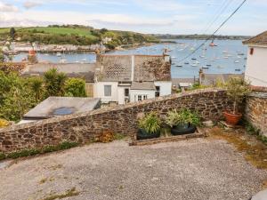 a stone retaining wall with a view of a harbor at Seabien in Falmouth