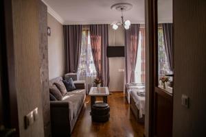 a living room with a couch and a table at Family Hotel Kolorit Old Tbilisi in Tbilisi City
