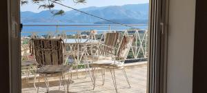 a group of chairs sitting on a balcony at Sea View apartment in Gythio