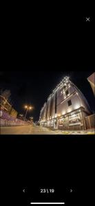 a picture of a building with lights on it at night at Golden Garden Hotel Suites in Riyadh