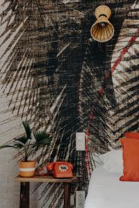a bedroom with a wall decorated with a mural at Hôtel PALMITO in Biarritz