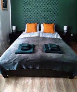 a bedroom with a large bed with two pillows on it at Apartament w Centrum Cichy Zakątek in Gliwice