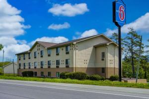 a building with a no parking sign next to a road at Motel 6-Montoursville, PA in Williamsport