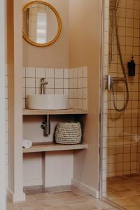 a bathroom with a sink and a shower at Hôtel PALMITO in Biarritz