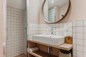 a bathroom with a sink and a mirror at Hôtel PALMITO in Biarritz +37 photos