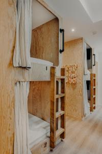 a room with two bunk beds and a staircase at Hôtel PALMITO in Biarritz