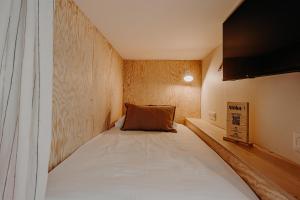 a small bedroom with a large bed in a room at Hôtel PALMITO in Biarritz