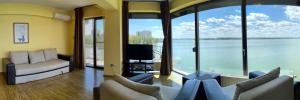 a living room with a view of the water at Apartment Hotel Tania Residence in Mamaia