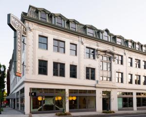 a large white building with a street sign in front of it at Hotel Grand Stark in Portland