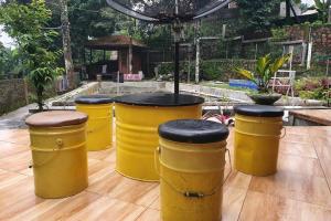 a row of yellow drums sitting on a wooden floor at Private Villa Dekke Boru, Bogor in Bogor