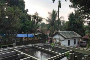 ボゴールにあるPrivate Villa Dekke Boru, Bogorの大きな水のプールが家の前にある
