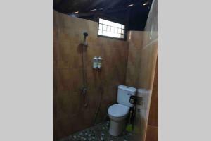 a bathroom with a toilet and a shower at Private Villa Dekke Boru, Bogor in Bogor