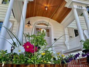 a flower arrangement on the front porch of a house at Buttonwood Boutique Hotel in West Cape May
