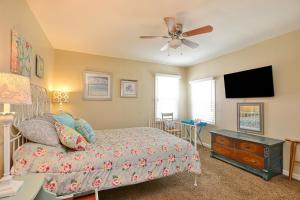 a bedroom with a bed and a flat screen tv at 432 Saratoga in Grover Beach