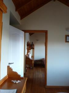 Habitación con pasillo con mesa y espejo. en Hostería Patagonia Jarke en Ushuaia