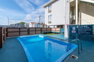 a swimming pool in front of a house at Hotel Charlee Villas Beach Hotel Oceanblock in Seaside Heights