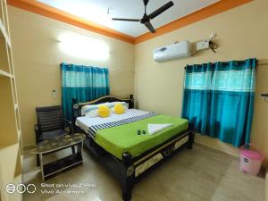a bedroom with a bed and a chair in it at Vizag homestay guest house in Visakhapatnam
