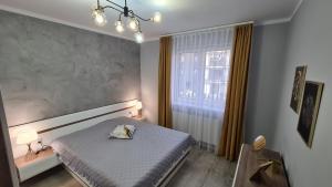 Кровать или кровати в номере Apartament DeLuxe 3