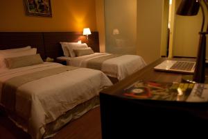 Letto o letti in una camera di Pine Tree Hotel