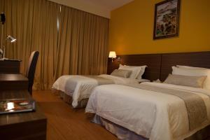 Letto o letti in una camera di Pine Tree Hotel