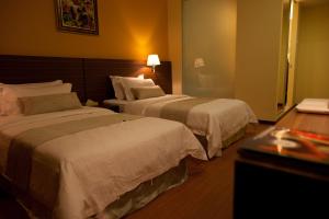 Letto o letti in una camera di Pine Tree Hotel