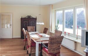 ein Esszimmer mit einem Holztisch und Stühlen in der Unterkunft Beautiful Home In Lutterbek With 3 Bedrooms And Wifi in Lutterbek