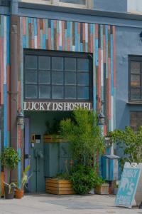 a building with a sign that reads lucky district hospital at Lucky D's Youth and Traveler's Hostel in San Diego