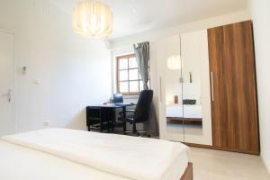 a bedroom with a bed and a desk and a mirror at Kuća za odmor Vladimir in Matulji