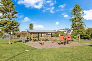 a playground in a park with a pavilion and trees at Family Vibes By Middleton Beach- Free Wifi in Middleton