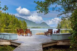 a dock with chairs and a view of a lake at Hotel Zed Tofino in Tofino