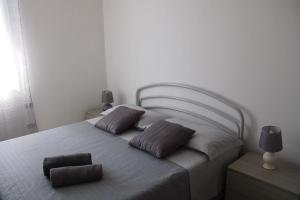 a bedroom with a bed with two pillows on it at Villa Cedrino Orosei in Orosei