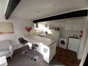 a kitchen with a white counter top in a room at Lemon Tree Apartment Tawa in Wellington