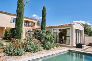 a house with a swimming pool in front of a house at Le Mas de Cink in Saint-Saturnin-dʼApt