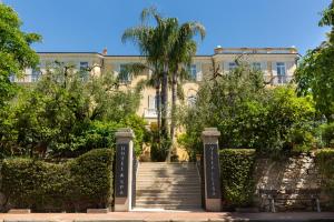 un edificio con scala di fronte a un edificio di Hotel Villa Elisa & Spa a Bordighera