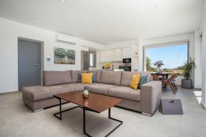 a living room with a couch and a table at Your House In Rhodes in Afantou